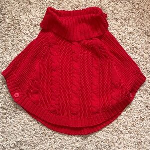 Size 5 red cable knit cape. Button on each side to create a space for each arm.